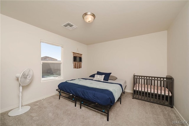 bedroom with carpet floors, baseboards, and visible vents