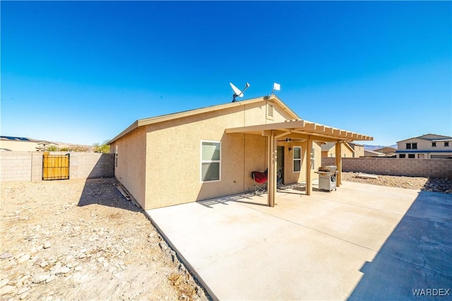 back of property with a patio area, a fenced backyard, and stucco siding