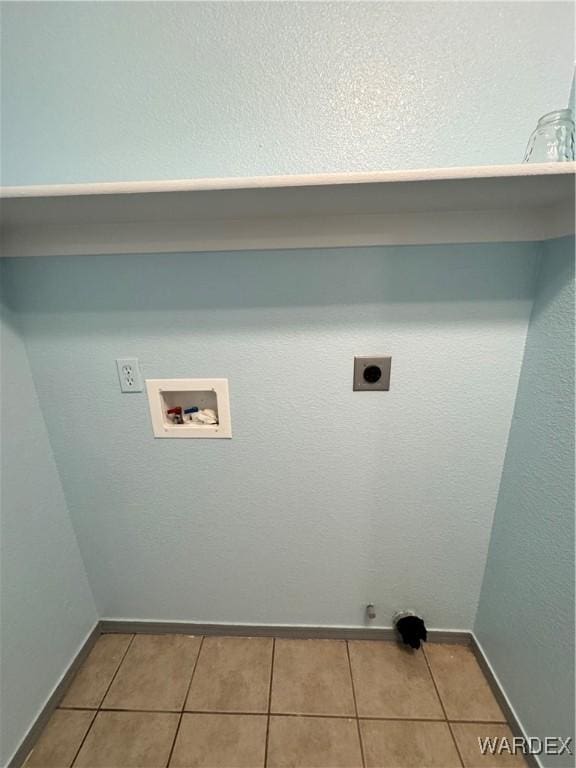 washroom with light tile patterned floors, laundry area, baseboards, hookup for a washing machine, and hookup for an electric dryer