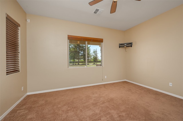 2303 E Hulet Ave, Mohave Valley, AZ 86440 - spare room featuring a ceiling fan, carpet flooring, and baseboards