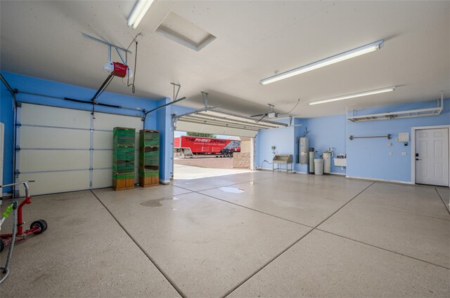 2303 E Hulet Ave, Mohave Valley, AZ 86440 - garage with gas water heater and a garage door opener