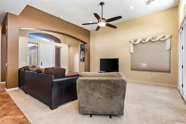 living area with recessed lighting, visible vents, arched walkways, and baseboards