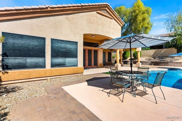 view of patio / terrace featuring fence and an outdoor pool