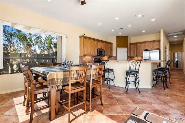 dining area with light tile patterned floors, visible vents, recessed lighting, and baseboards