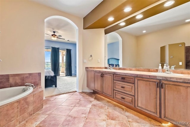 full bath featuring ceiling fan, double vanity, ensuite bathroom, and a sink