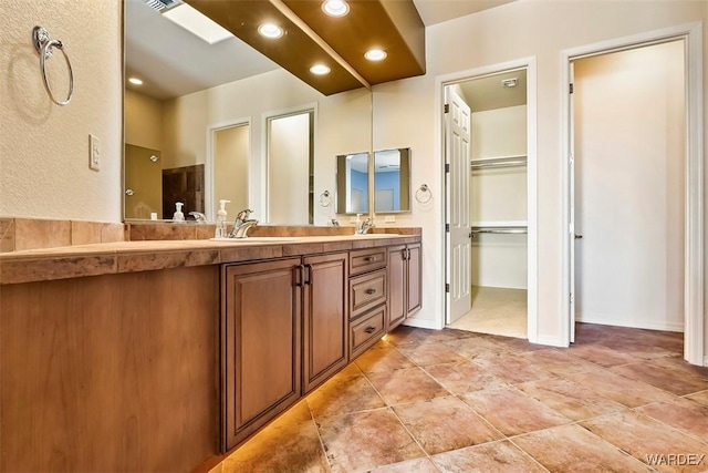 bathroom featuring tile patterned floors, visible vents, a sink, recessed lighting, and double vanity