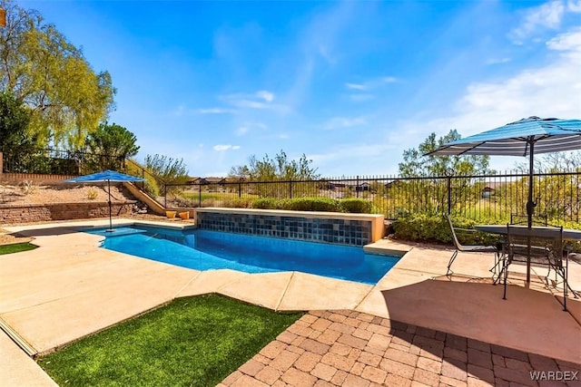 view of swimming pool featuring a patio area, a fenced backyard, and a fenced in pool