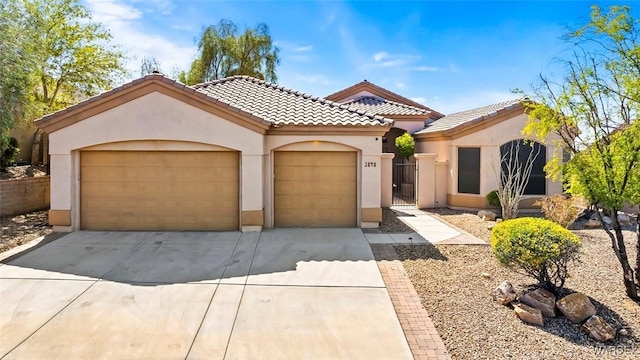 mediterranean / spanish home with stucco siding, an attached garage, driveway, and a tile roof