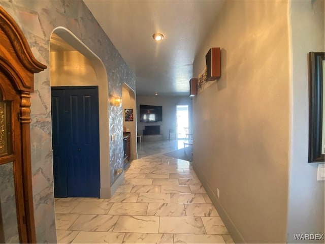 211 Columbine Dr, Lake Havasu, AZ 86403 - corridor featuring baseboards, arched walkways, and marble finish floor