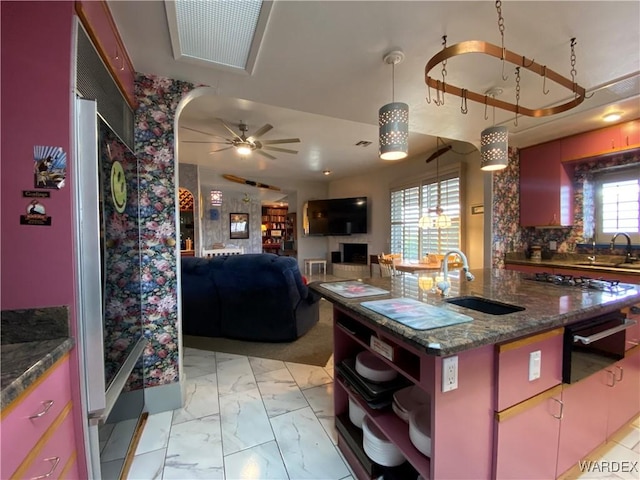 211 Columbine Dr, Lake Havasu, AZ 86403 - kitchen featuring ceiling fan, a sink, marble finish floor, a warming drawer, and an island with sink