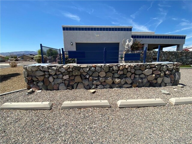 211 Columbine Dr, Lake Havasu, AZ 86403 - view of side of home with an attached garage, fence private yard, and stucco siding