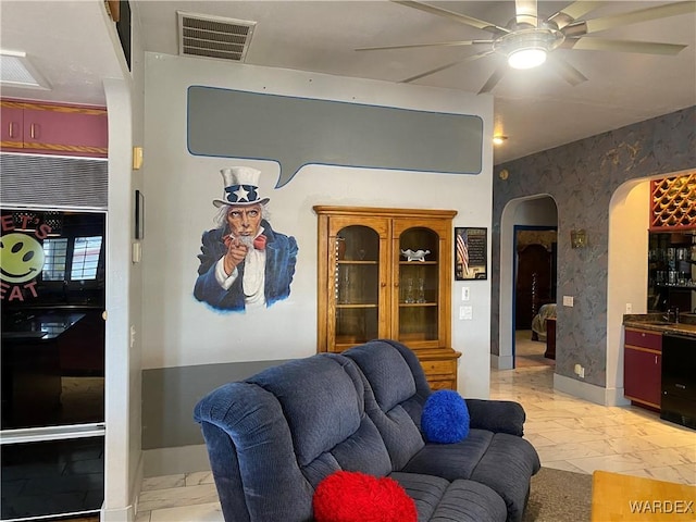 211 Columbine Dr, Lake Havasu, AZ 86403 - living room with arched walkways, ceiling fan, baseboards, and visible vents