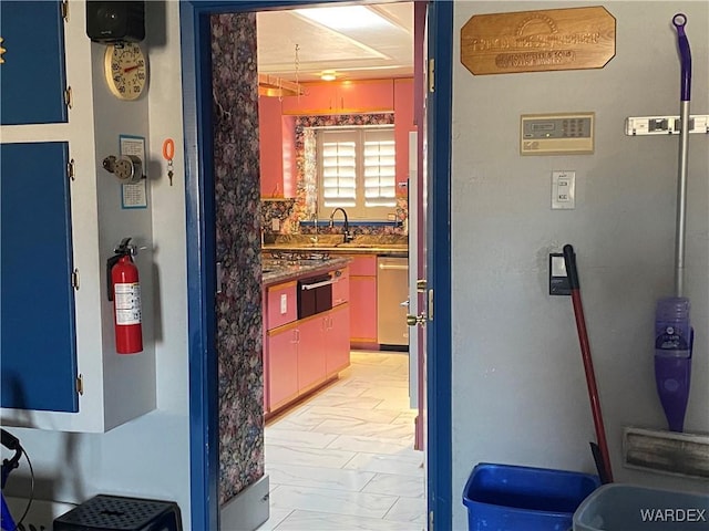 211 Columbine Dr, Lake Havasu, AZ 86403 - kitchen featuring dark countertops, dishwasher, a sink, marble finish floor, and a warming drawer