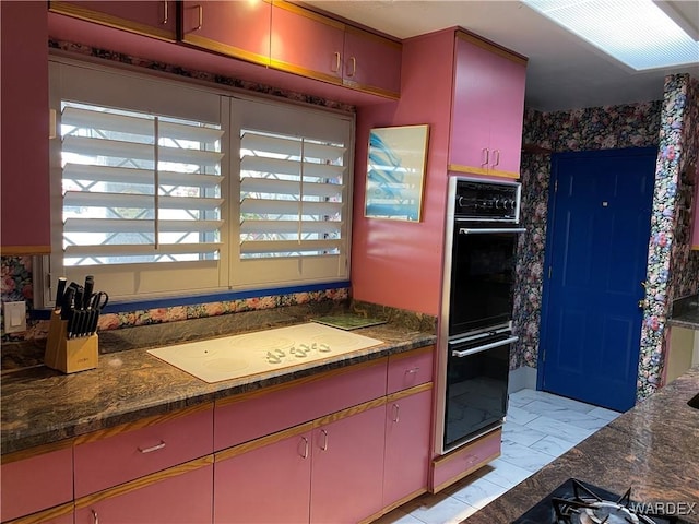 211 Columbine Dr, Lake Havasu, AZ 86403 - kitchen with red cabinets, dobule oven black, white electric cooktop, and marble finish floor
