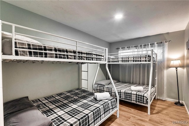 bedroom with wood finished floors and baseboards