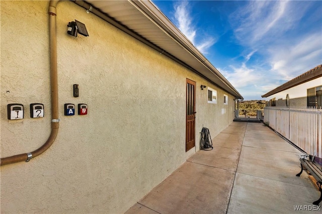 view of property exterior featuring fence and stucco siding