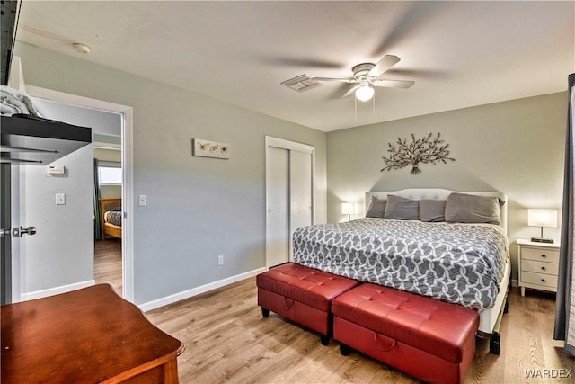 bedroom with a closet, visible vents, light wood-style floors, a ceiling fan, and baseboards