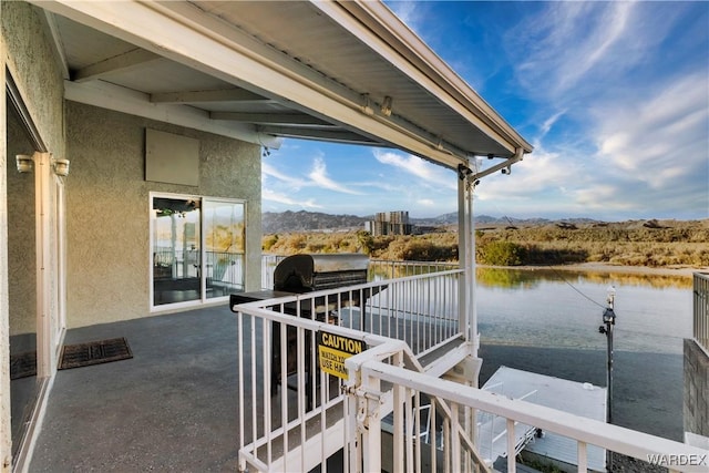 balcony featuring a water view and area for grilling