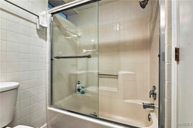 full bathroom featuring toilet, enclosed tub / shower combo, and tile walls