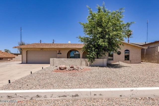 view of front of home with a garage, concrete driveway, and stucco siding