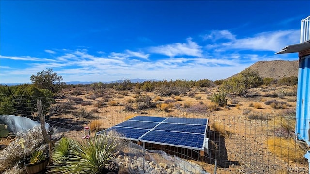 exterior space featuring solar panels and a mountain view