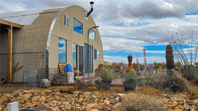 view of side of property featuring an outbuilding