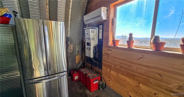 kitchen with a wall unit AC, wooden walls, and freestanding refrigerator