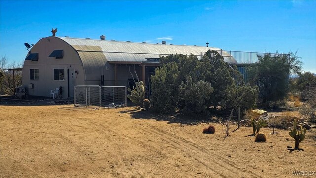 rear view of house with an outdoor structure and a barn