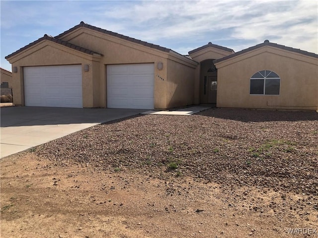 single story home with driveway, stucco siding, and an attached garage
