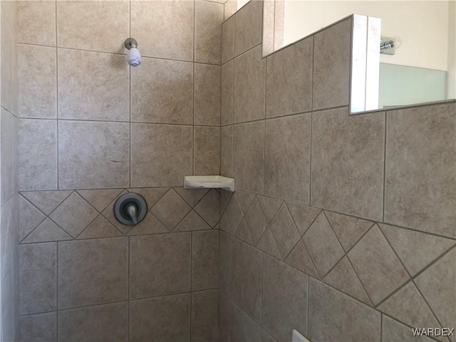 interior details featuring a tile shower