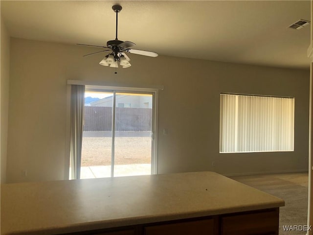 interior space featuring visible vents and ceiling fan
