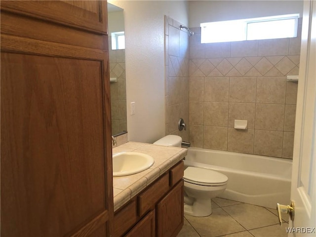full bathroom with  shower combination, toilet, tile patterned flooring, and a healthy amount of sunlight