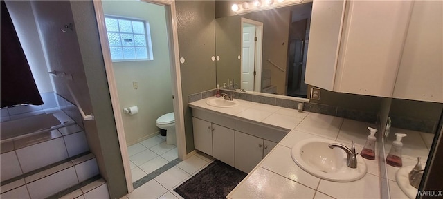 full bath featuring double vanity, tile patterned flooring, toilet, and a sink