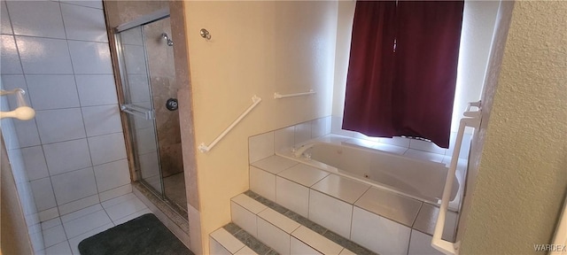 bathroom with a shower stall and a bath