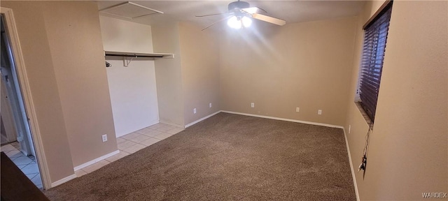 unfurnished bedroom featuring tile patterned flooring, carpet, and ceiling fan