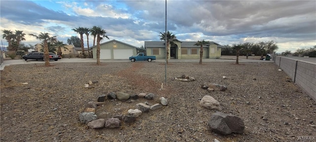 view of yard featuring a garage and fence