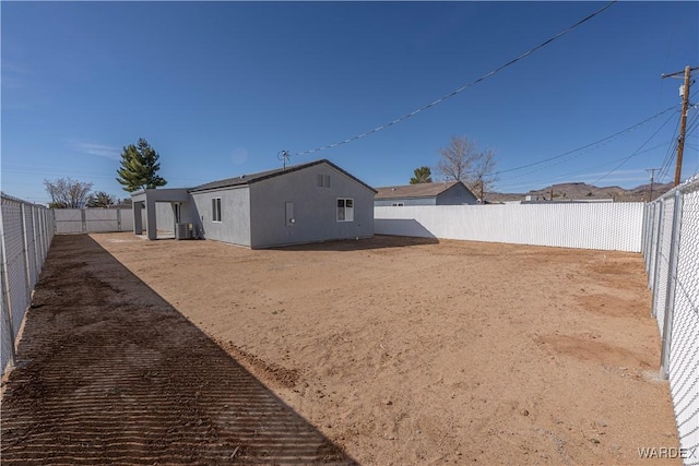 view of yard featuring central AC and a fenced backyard