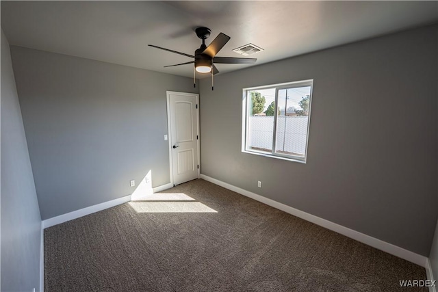 spare room with a ceiling fan, carpet flooring, visible vents, and baseboards