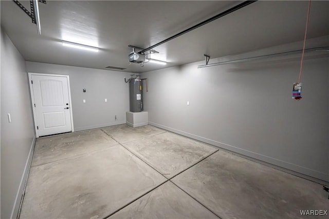 garage featuring a garage door opener, electric water heater, and baseboards