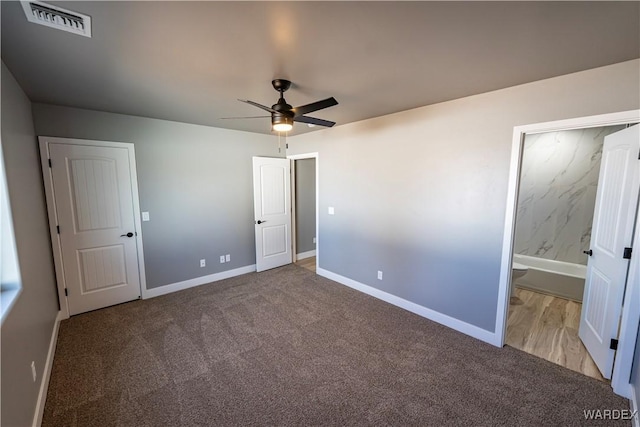 unfurnished bedroom featuring connected bathroom, carpet flooring, visible vents, and baseboards