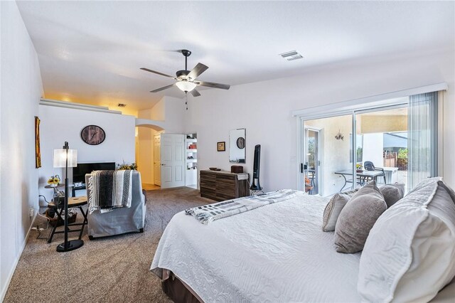 6053 S Klamath Loop, Fort Mohave, AZ 86426 - bedroom with arched walkways, access to outside, carpet flooring, vaulted ceiling, and a ceiling fan