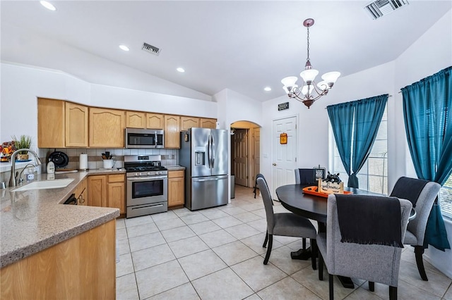 6053 S Klamath Loop, Fort Mohave, AZ 86426 - kitchen with appliances with stainless steel finishes, arched walkways, a chandelier, vaulted ceiling, and light tile patterned floors