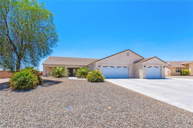 6053 S Klamath Loop, Fort Mohave, AZ 86426 - ranch-style house with a garage, driveway, and stucco siding