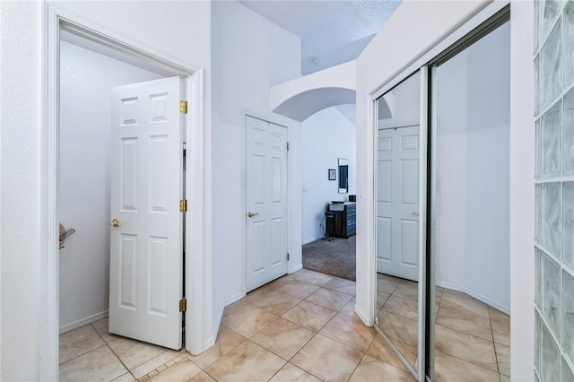 6053 S Klamath Loop, Fort Mohave, AZ 86426 - hallway with light tile patterned floors and arched walkways