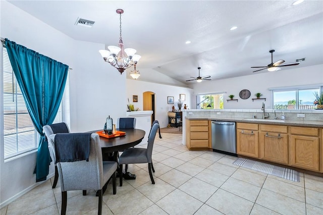 6053 S Klamath Loop, Fort Mohave, AZ 86426 - kitchen with stainless steel dishwasher, arched walkways, vaulted ceiling, light countertops, and decorative light fixtures