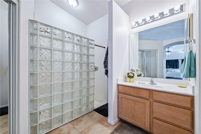6053 S Klamath Loop, Fort Mohave, AZ 86426 - bathroom featuring vanity, a walk in shower, tile patterned flooring, and a ceiling fan