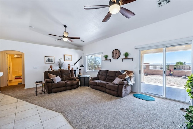 6053 S Klamath Loop, Fort Mohave, AZ 86426 - living area with light colored carpet, ceiling fan, arched walkways, light tile patterned floors, and vaulted ceiling