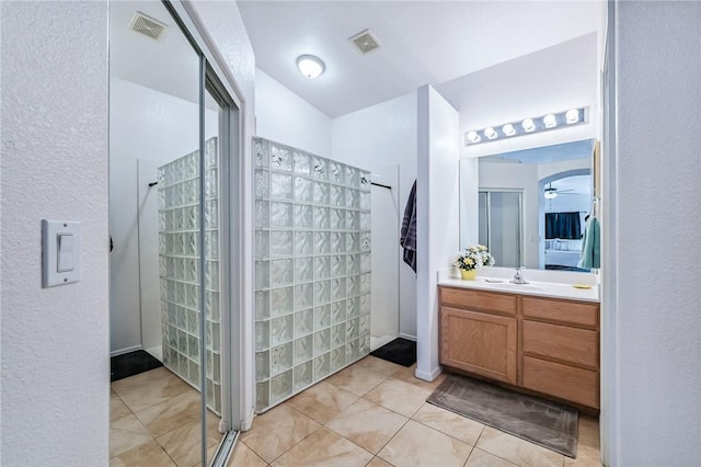 6053 S Klamath Loop, Fort Mohave, AZ 86426 - ensuite bathroom with a walk in shower, vanity, and tile patterned flooring