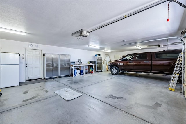 6053 S Klamath Loop, Fort Mohave, AZ 86426 - garage with freestanding refrigerator and a garage door opener
