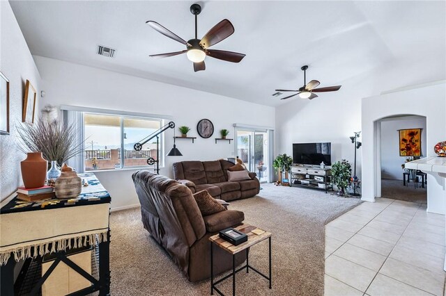 6053 S Klamath Loop, Fort Mohave, AZ 86426 - living area with a ceiling fan, healthy amount of natural light, light carpet, vaulted ceiling, and light tile patterned floors